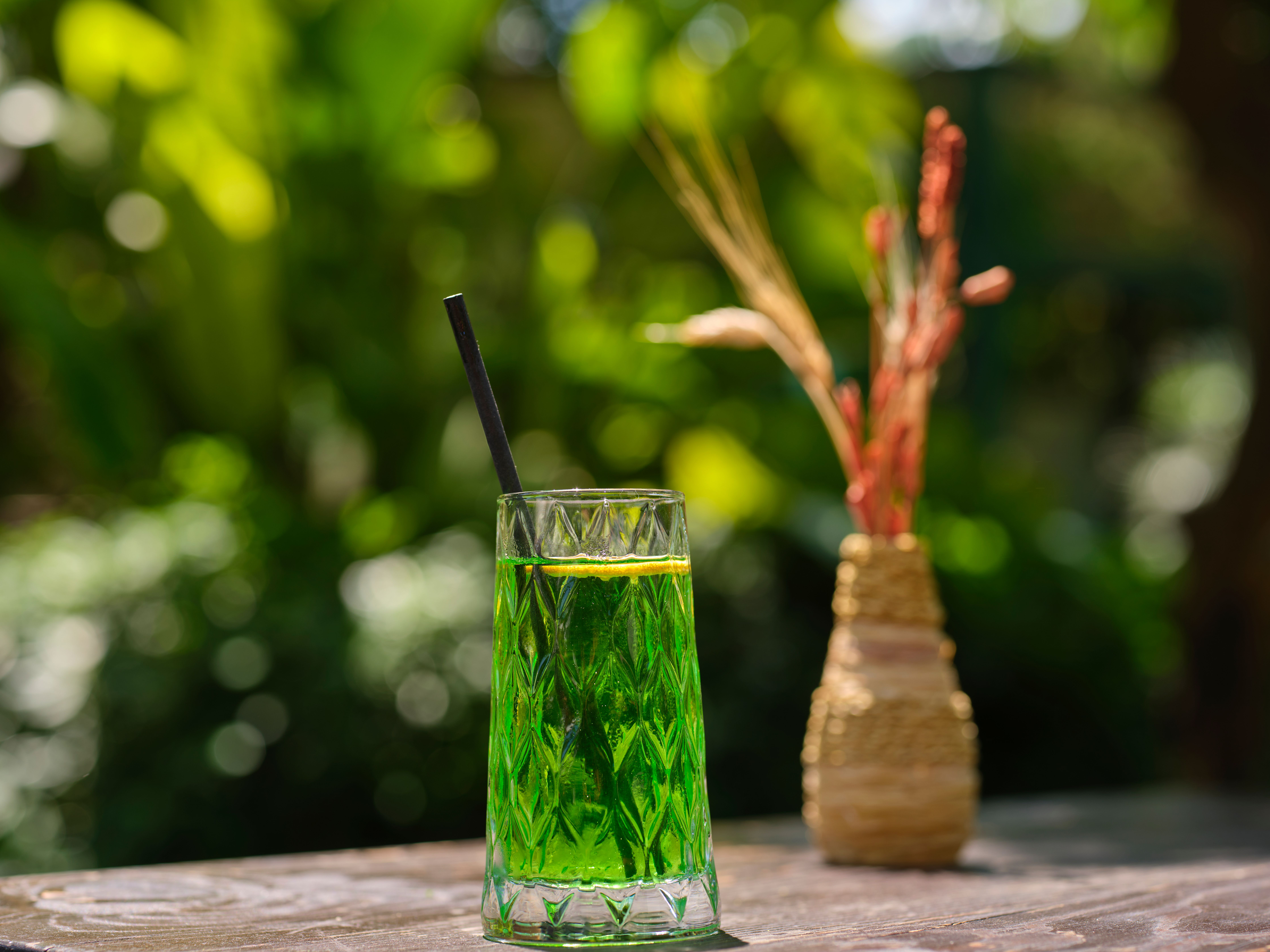 Iced beverage on a wooden garden table