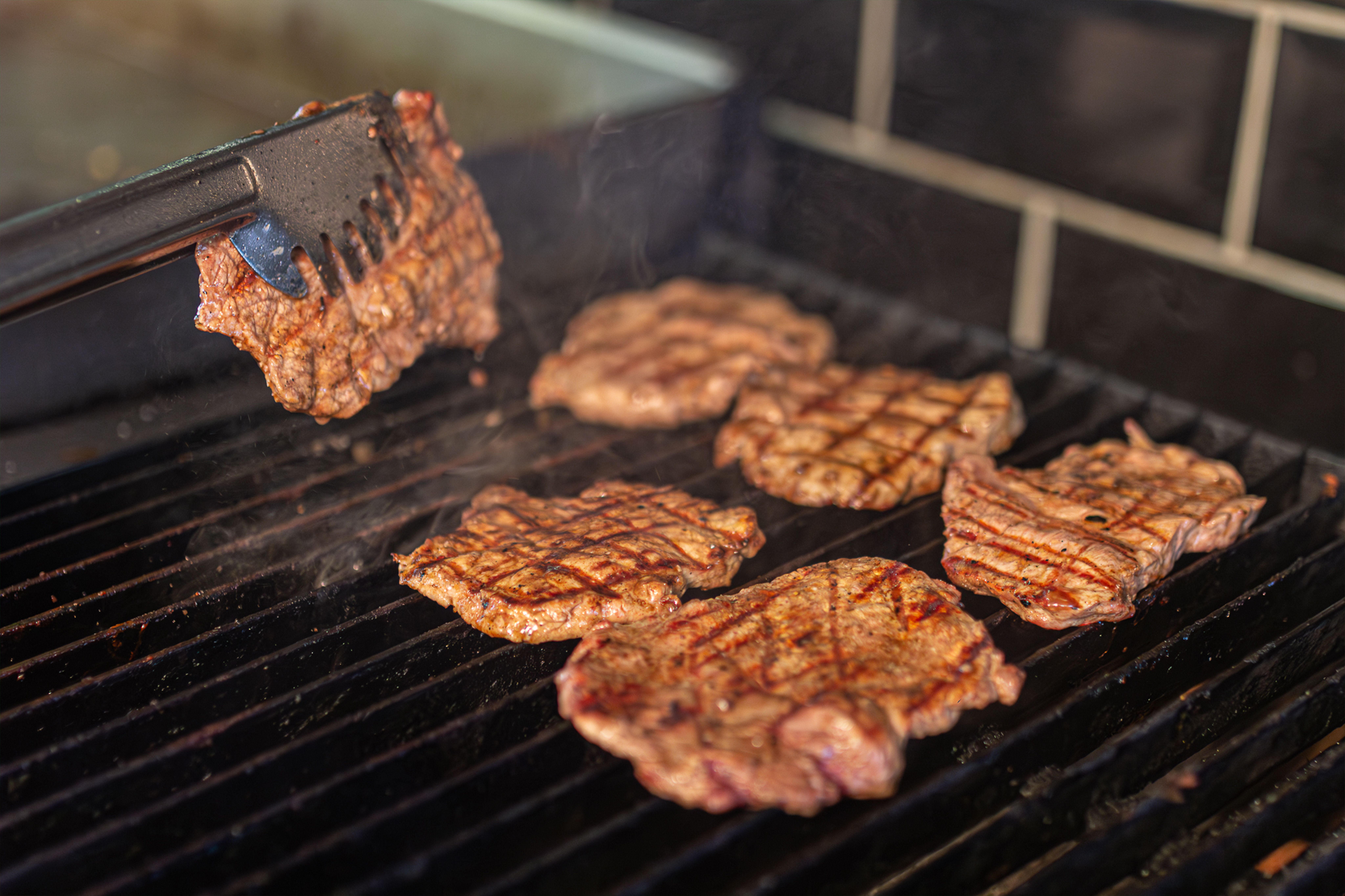 Professional grill area with sizzling ingredients