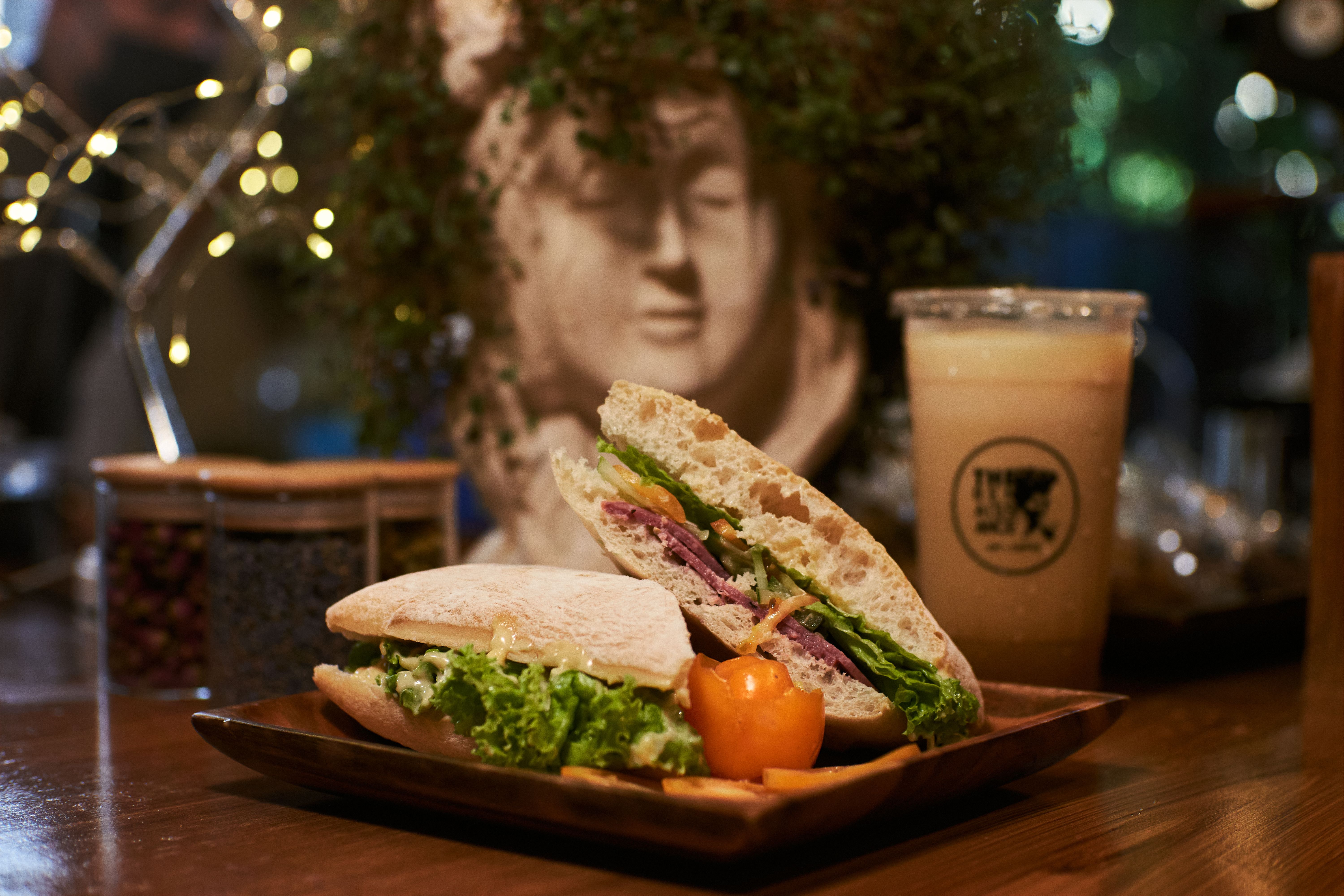 Cold glass of ayran next to a sandwich