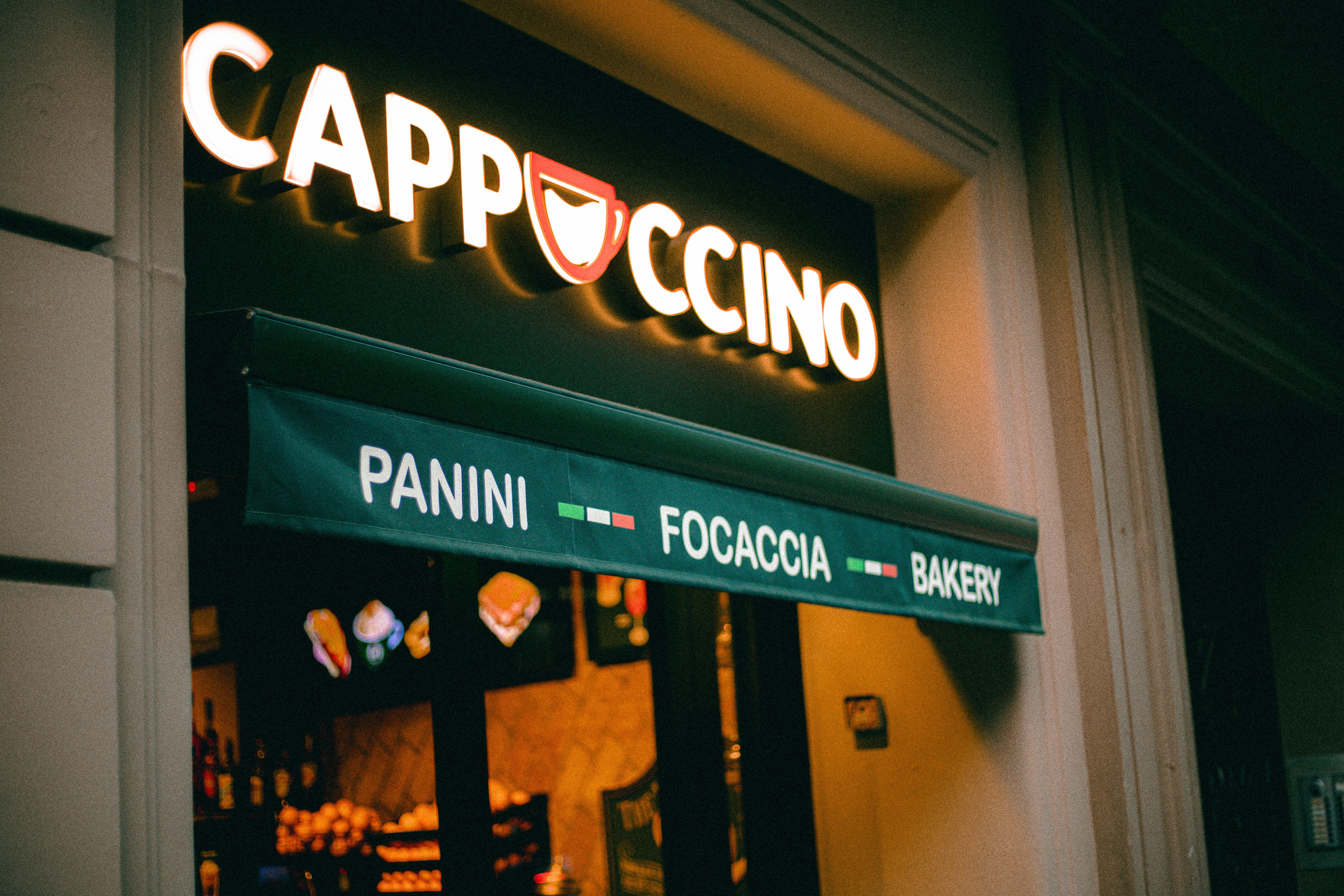 View of the cafe entrance through a large glass window