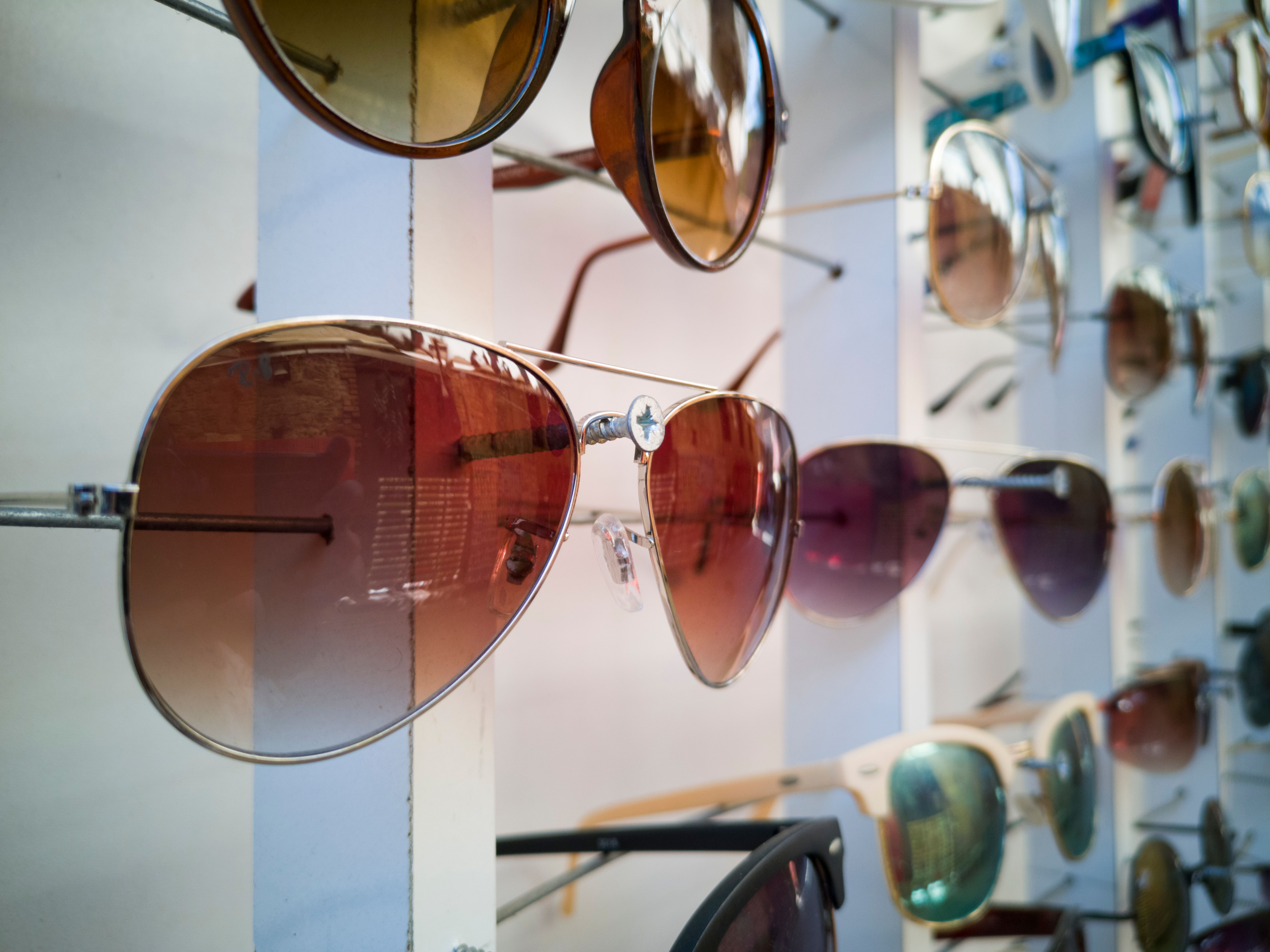Retro sunglasses displayed on a minimalist glass shelf
