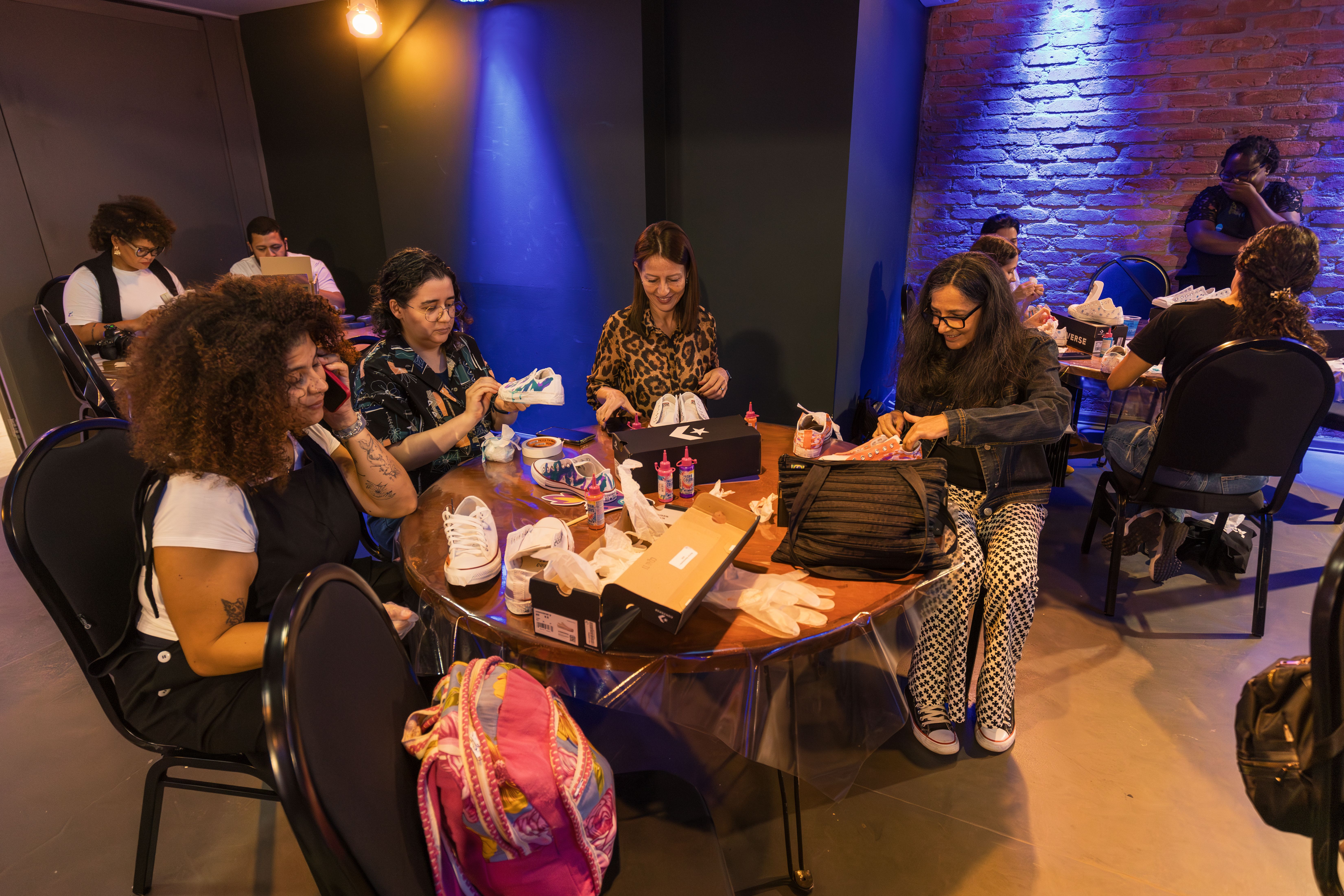 Group of people gathered around a table for a textile workshop