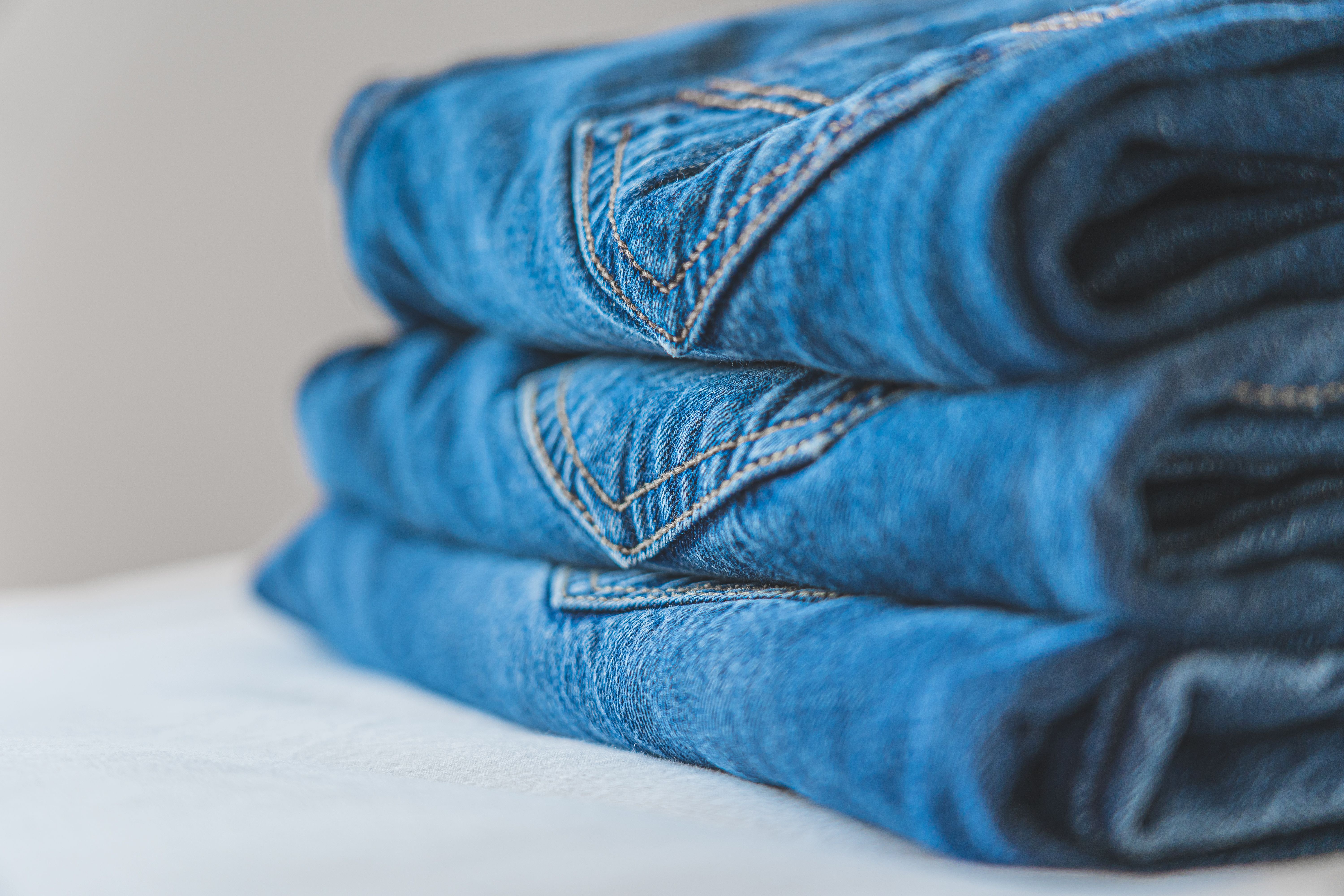 Stack of neatly folded vintage denim jeans