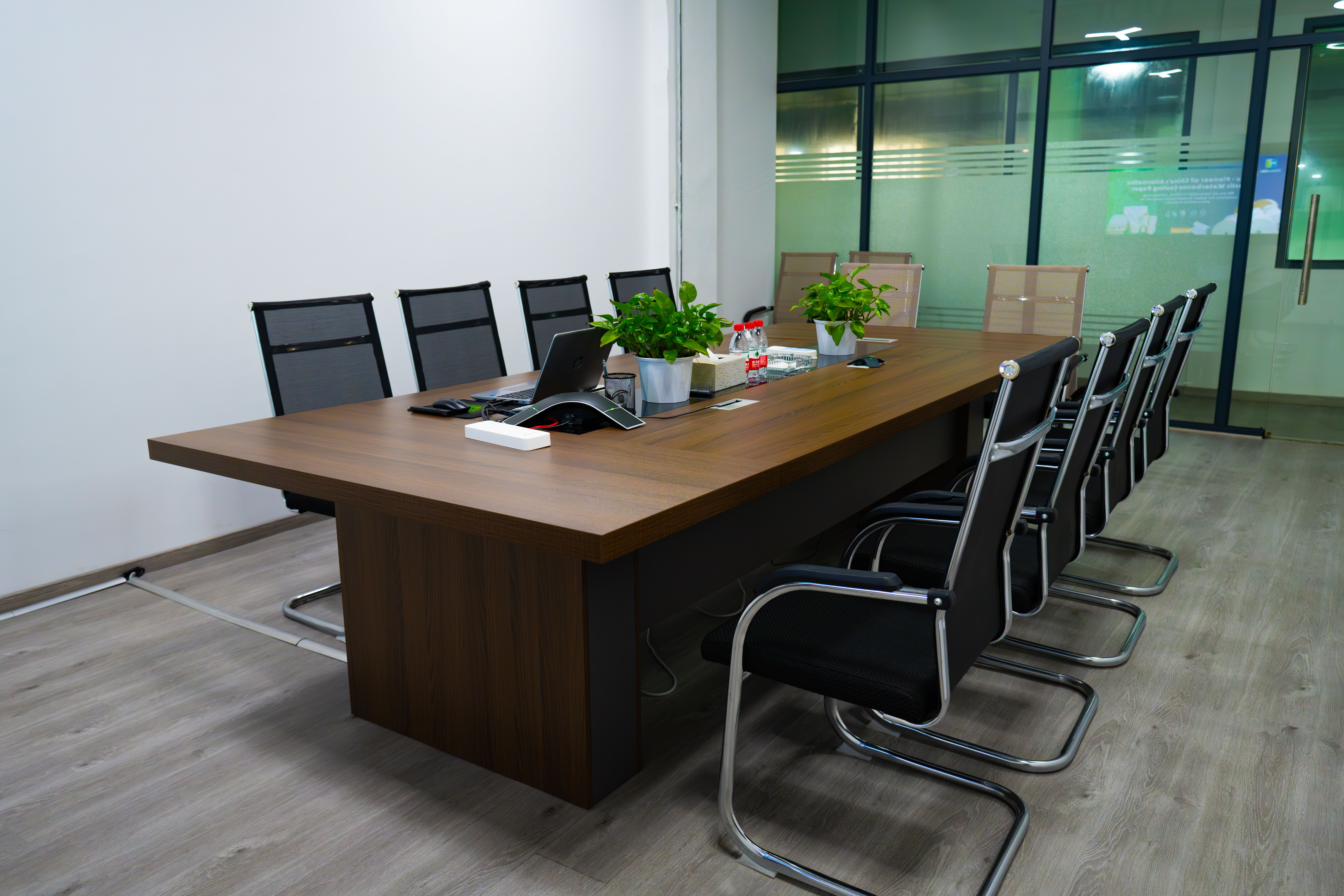 Bright meeting room with glass walls and chairs