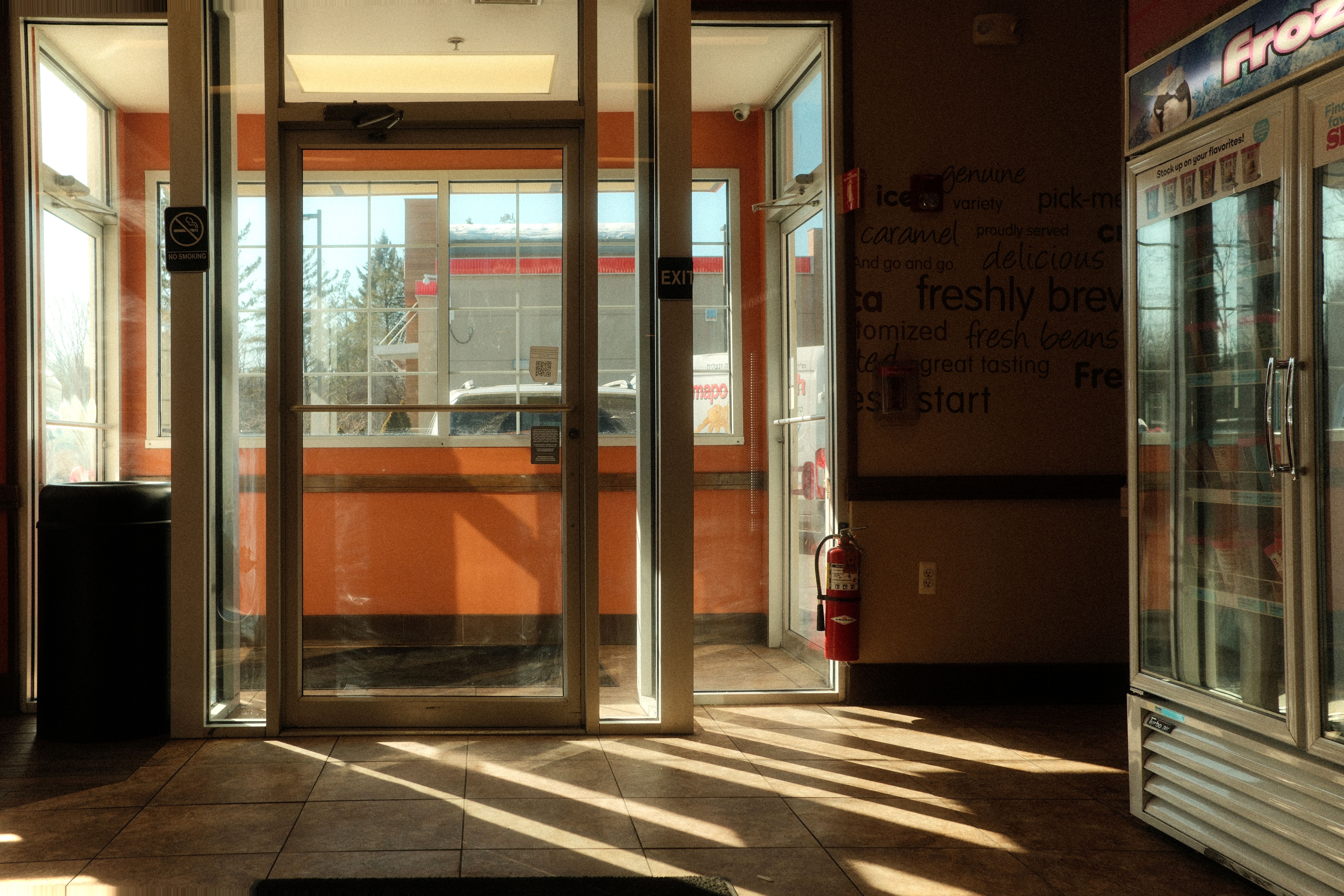 A modern glass office door with a professional logo