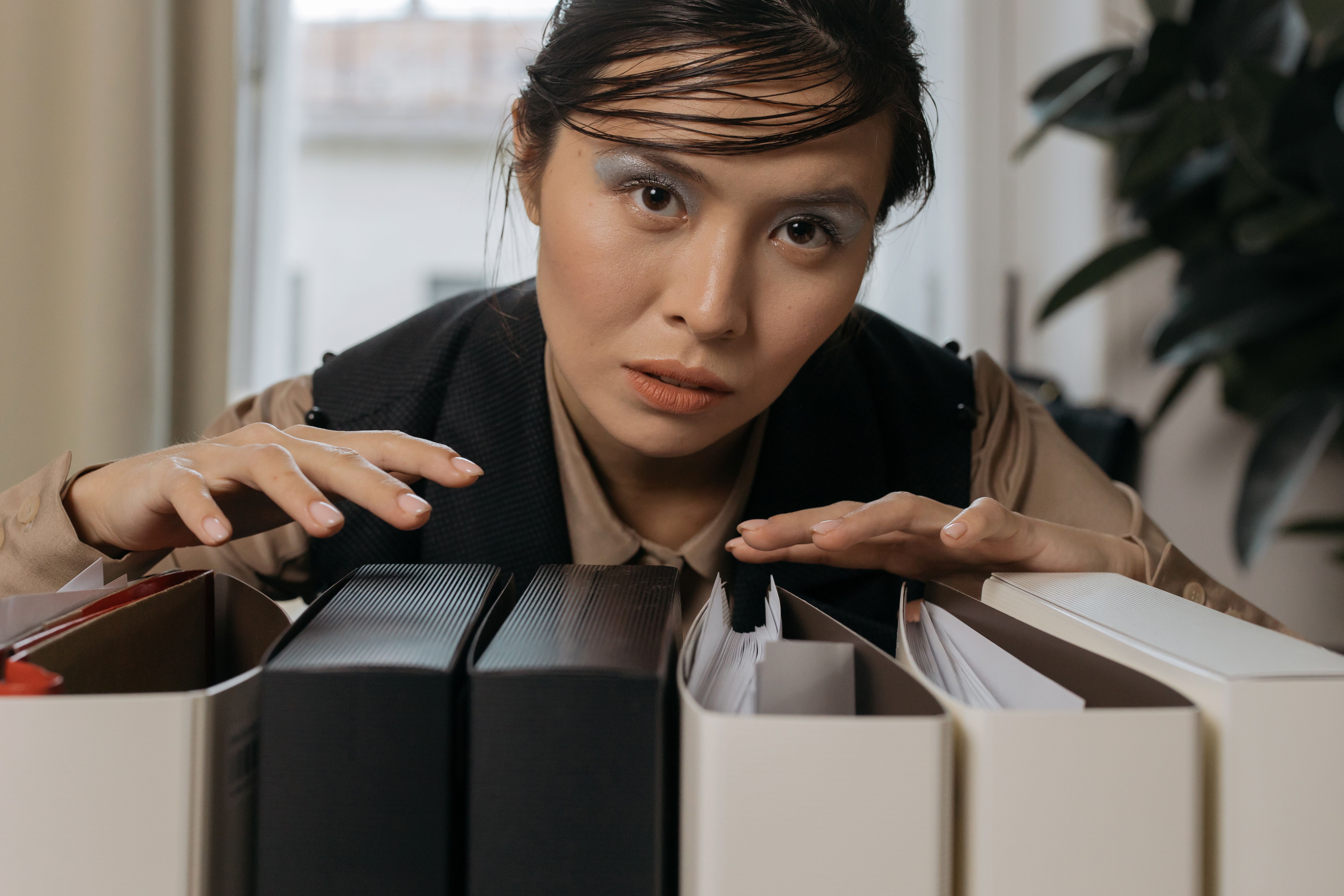 Hands of a professional organizing documents into a lever arch file