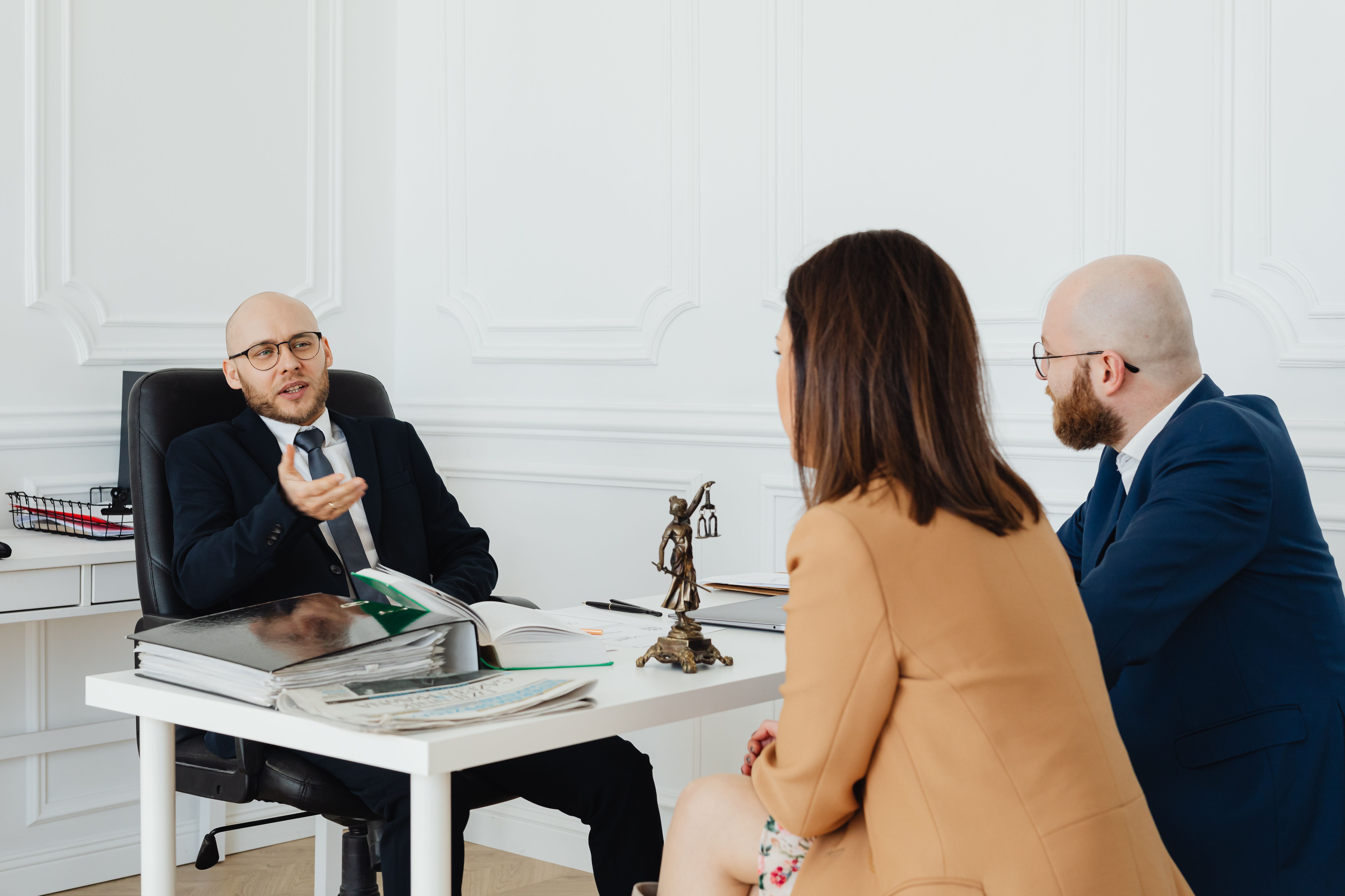 Two people sitting at a desk having a professional discussion