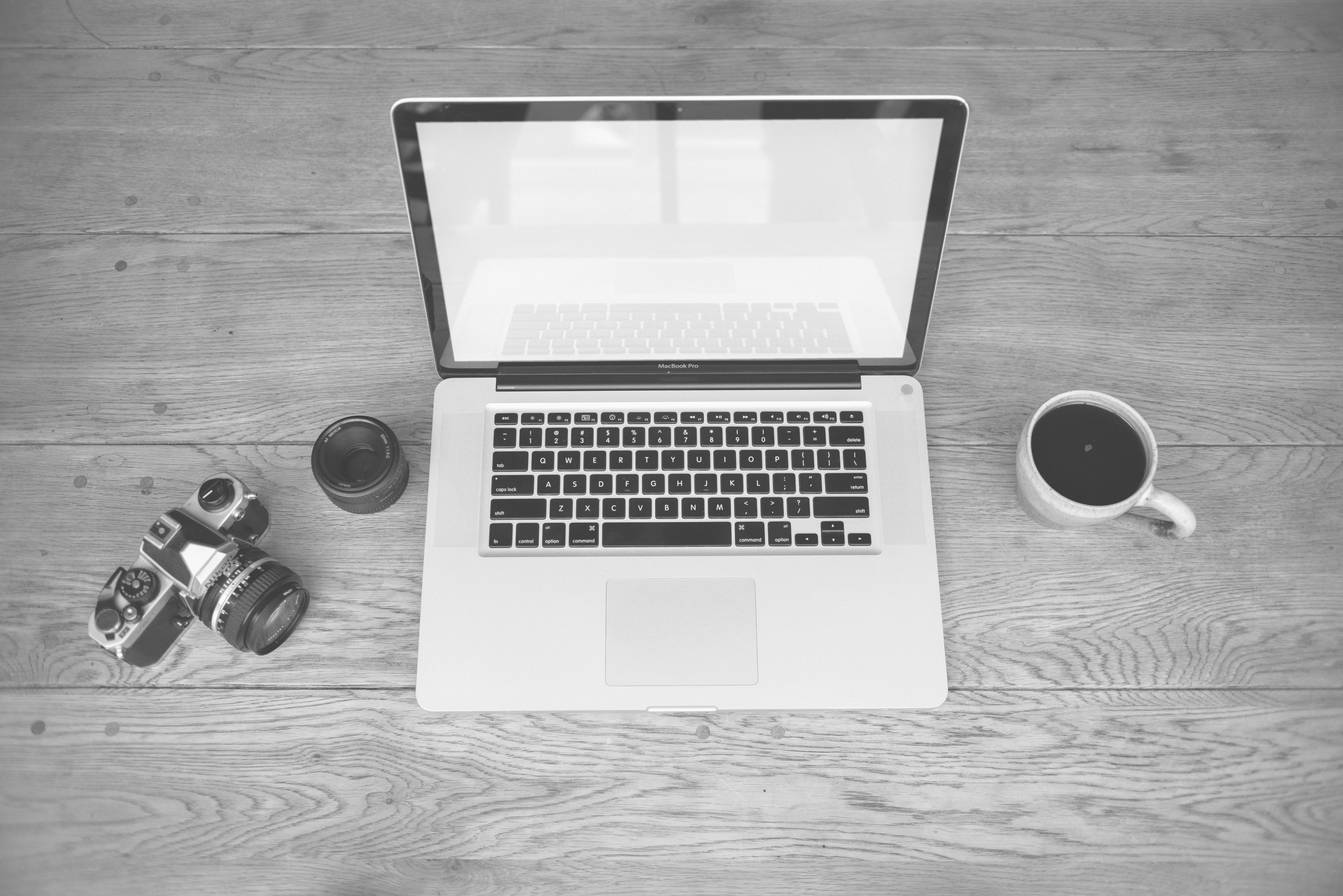 Clean office desk with a coffee cup and a laptop