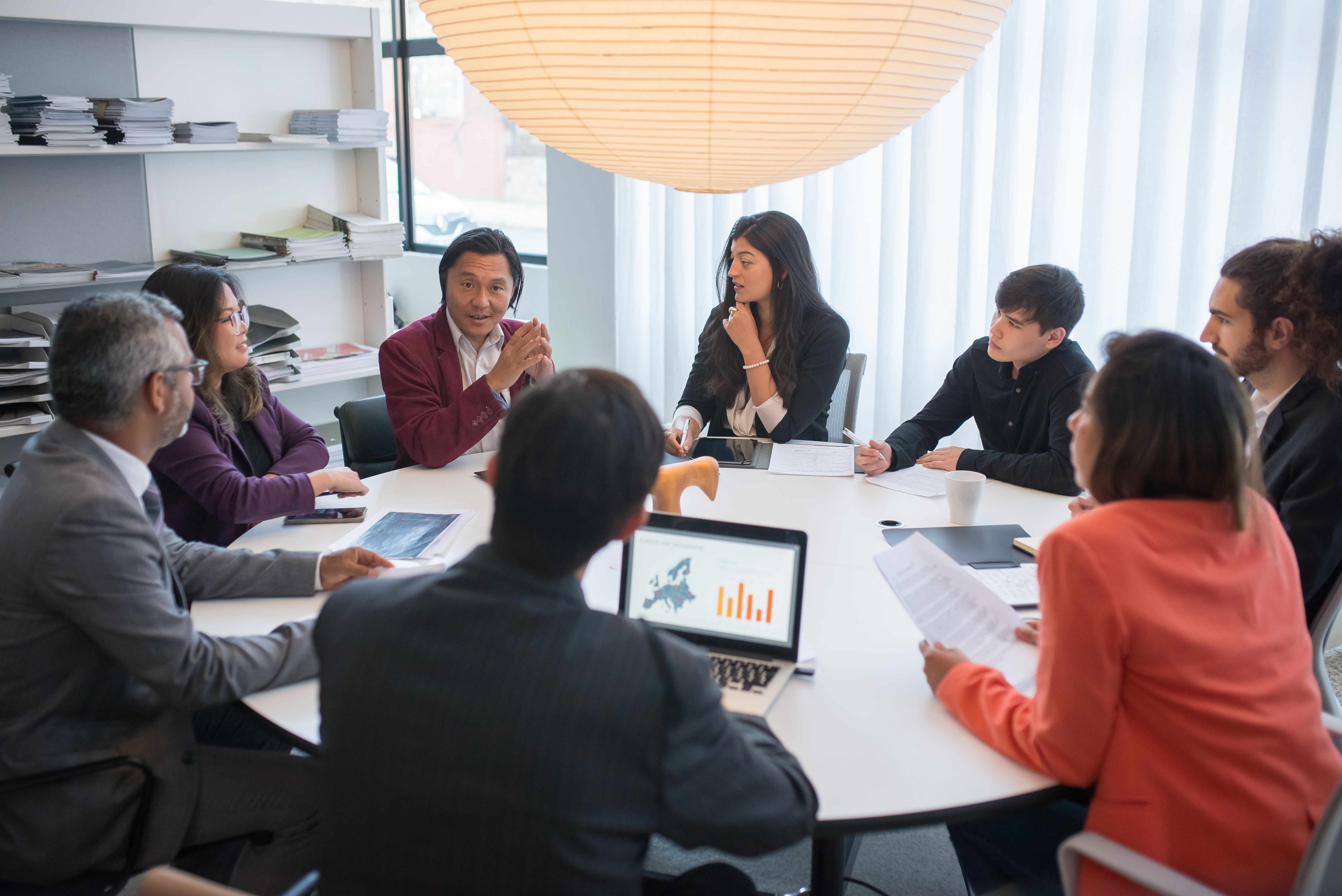 Team meeting around a large wooden table