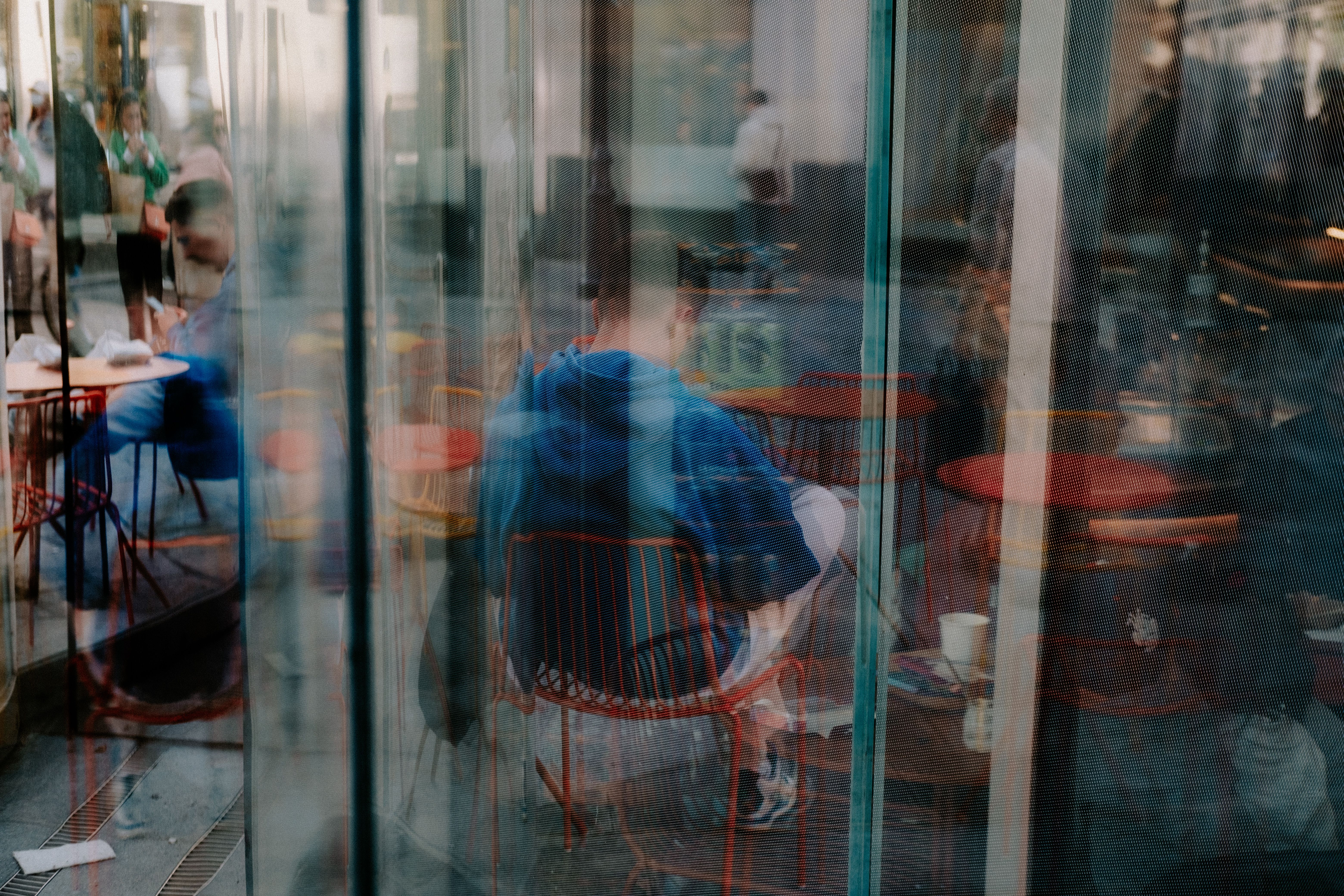 Large window of the cafe overlooking the mall interior