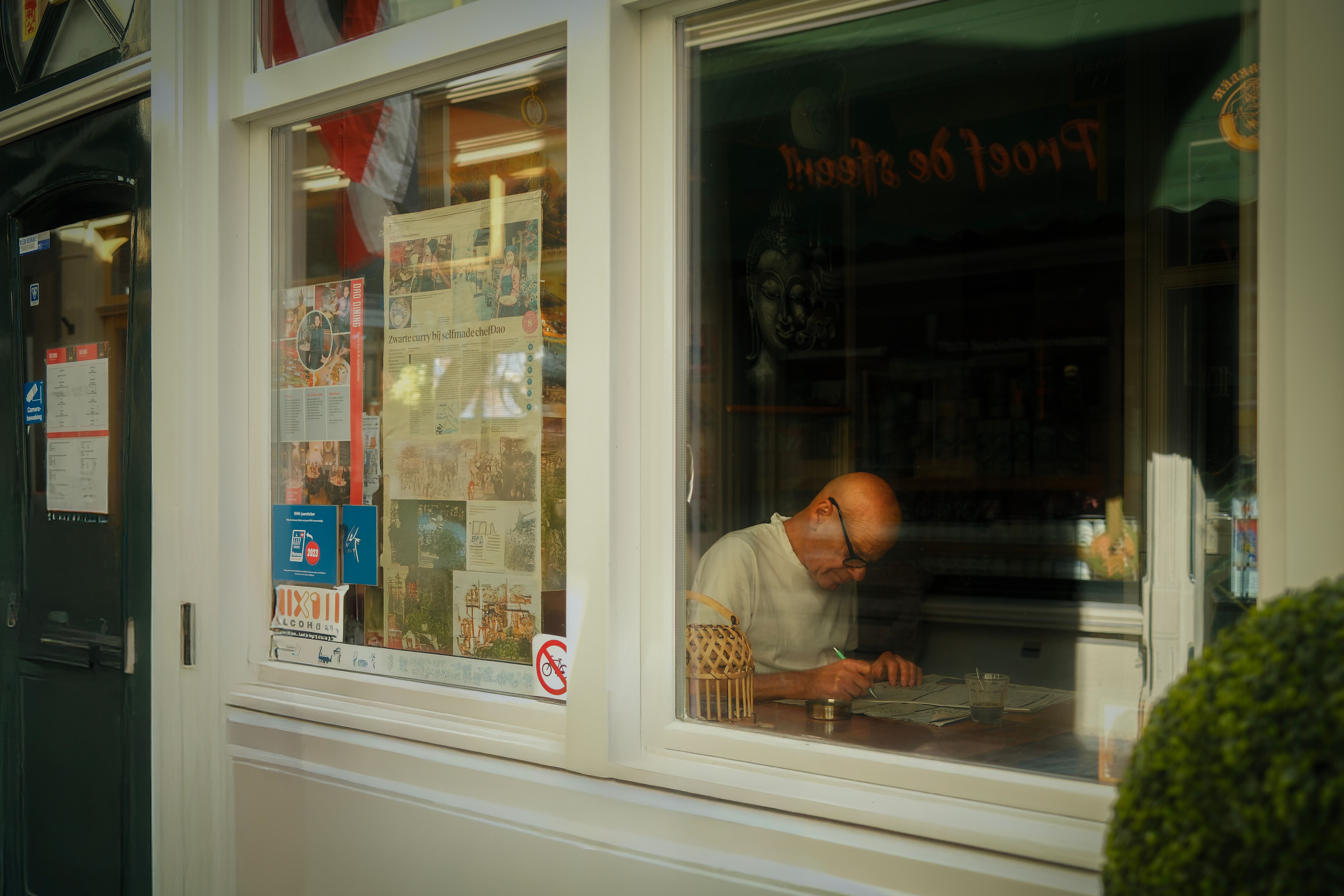 A glass of tea next to a morning newspaper