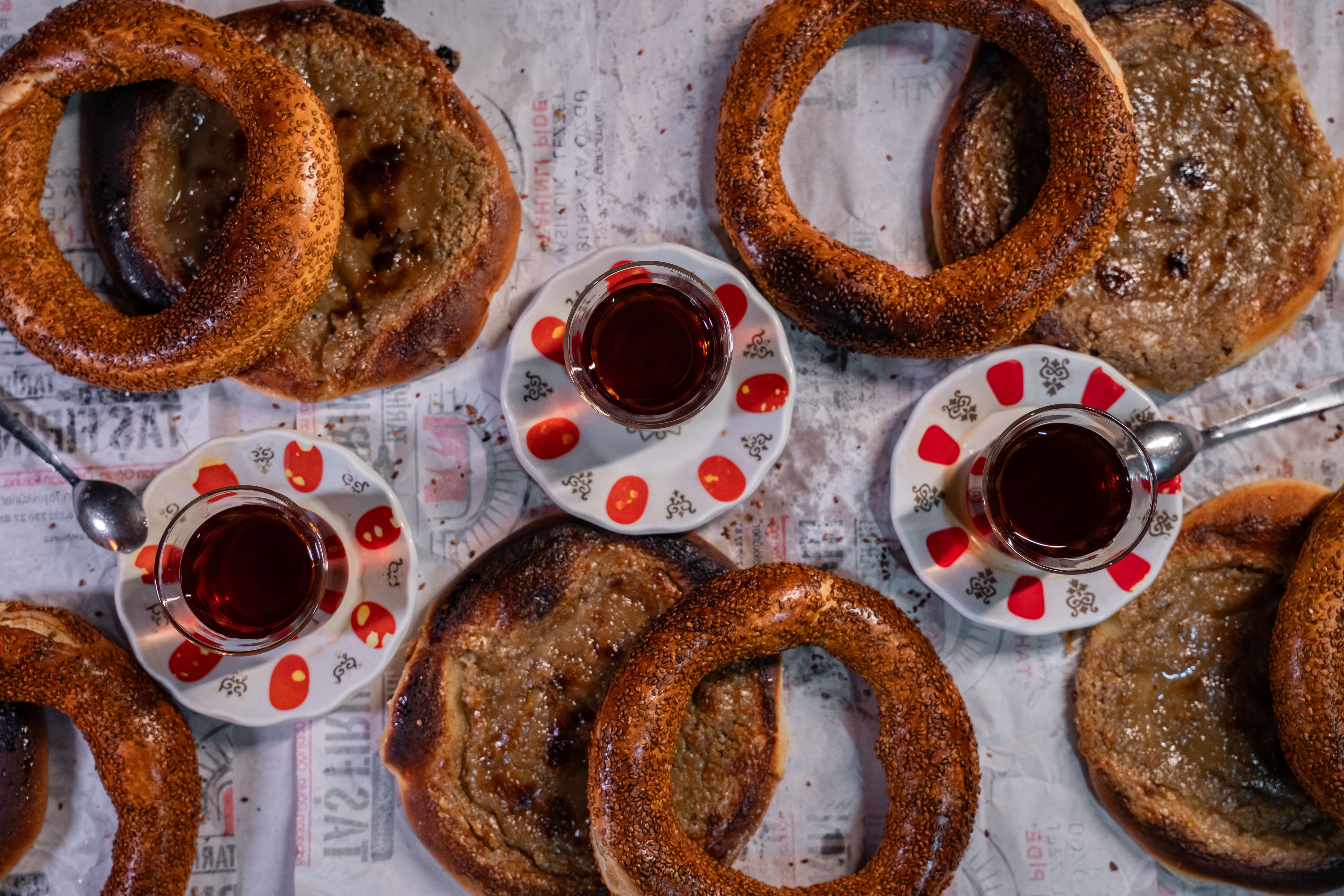 Hands breaking a piece of fresh simit