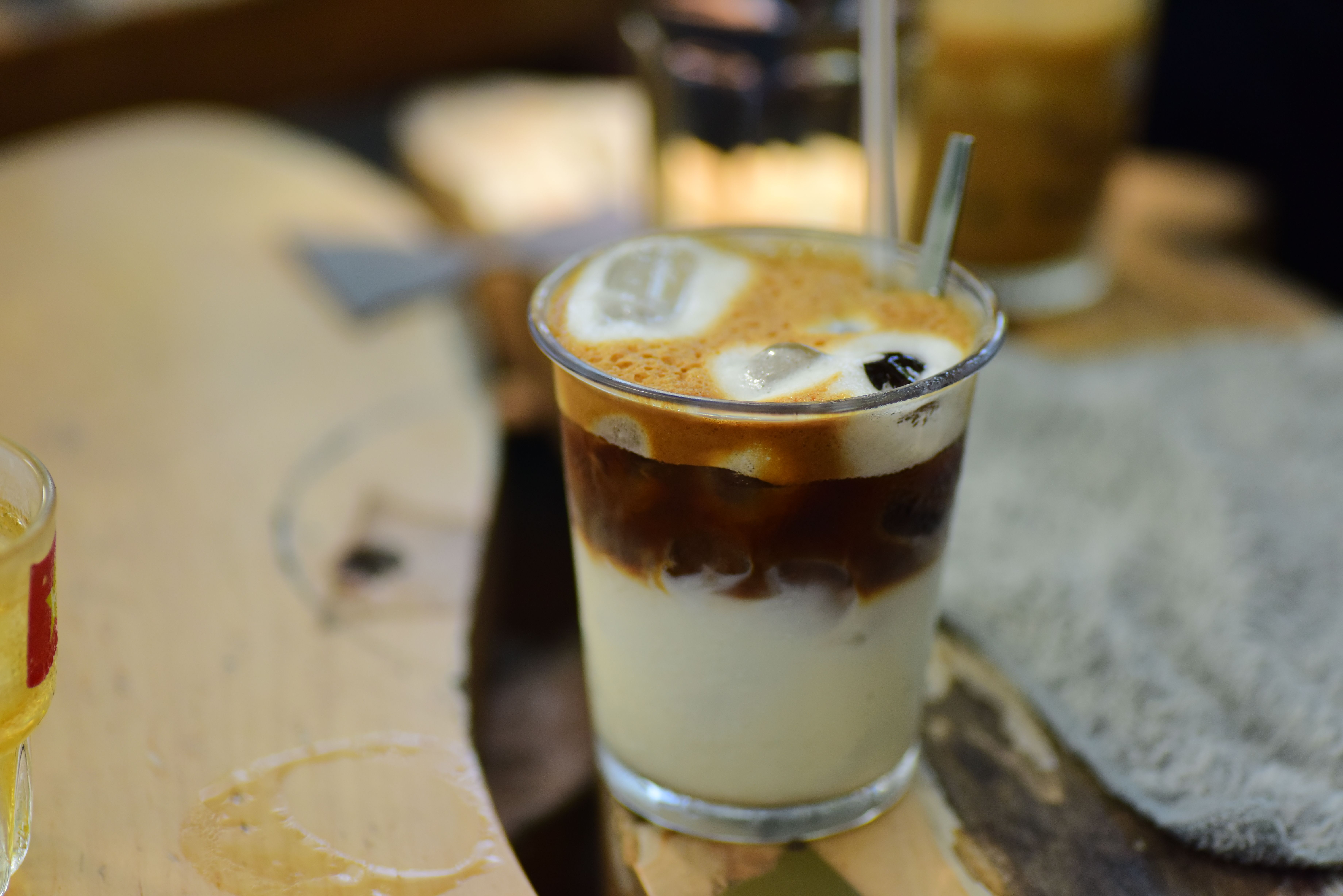 Iced latte with milk swirls in a tall glass