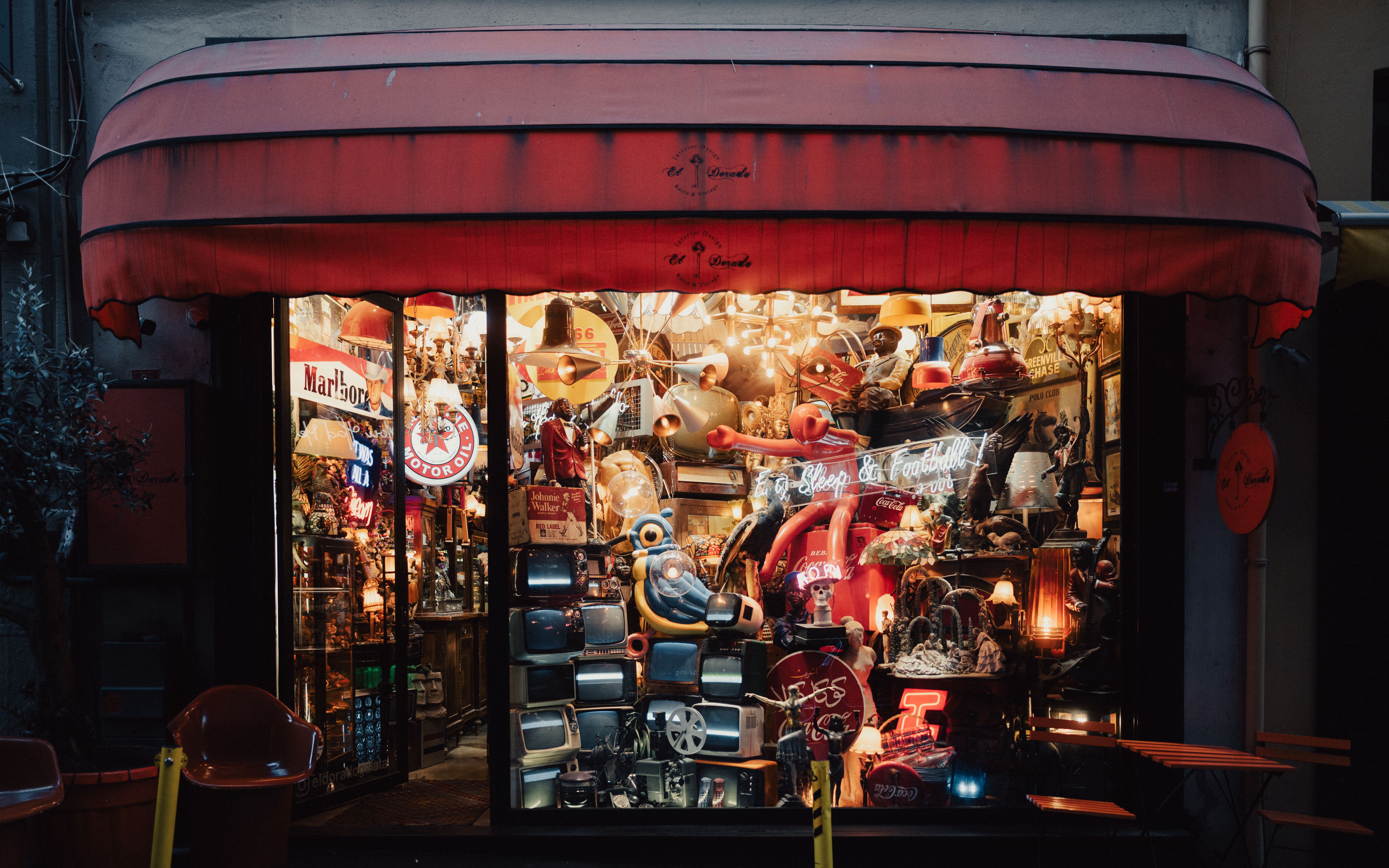 Storefront of a vintage shop with glass windows and wooden door