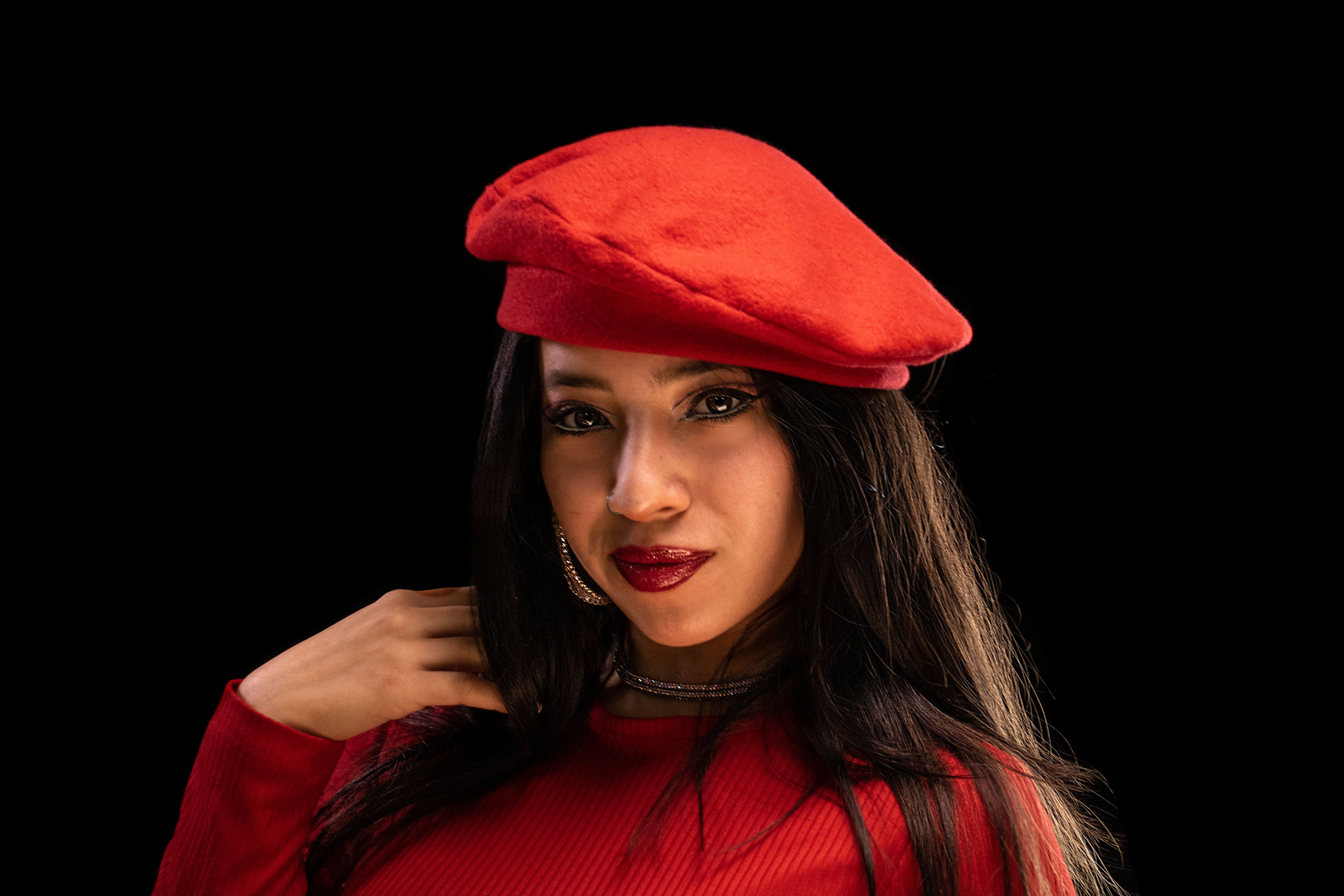 Woman wearing a vintage wool beret walking in a Lisbon neighborhood.