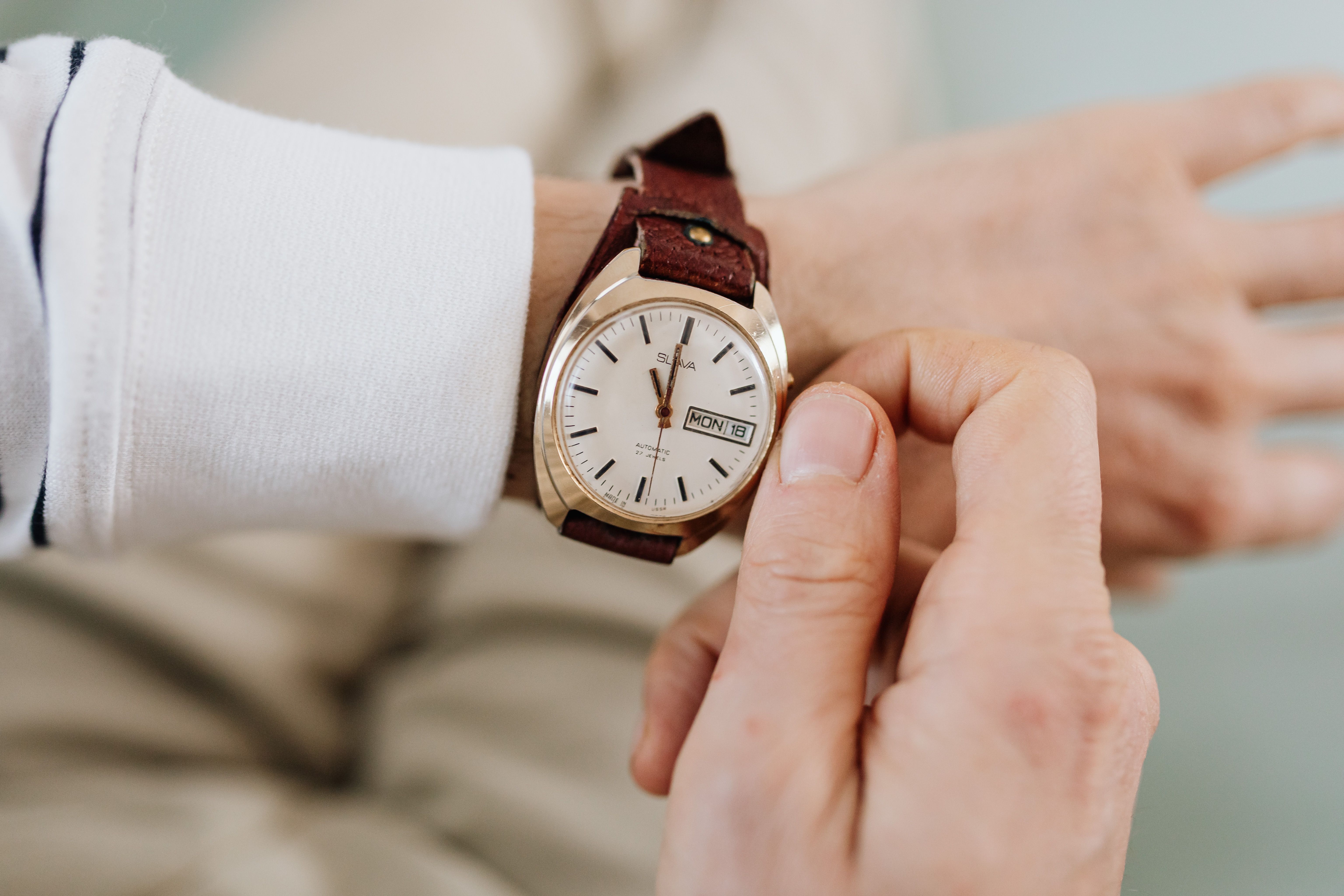 Close up of a vintage gold watch on a person's wrist.