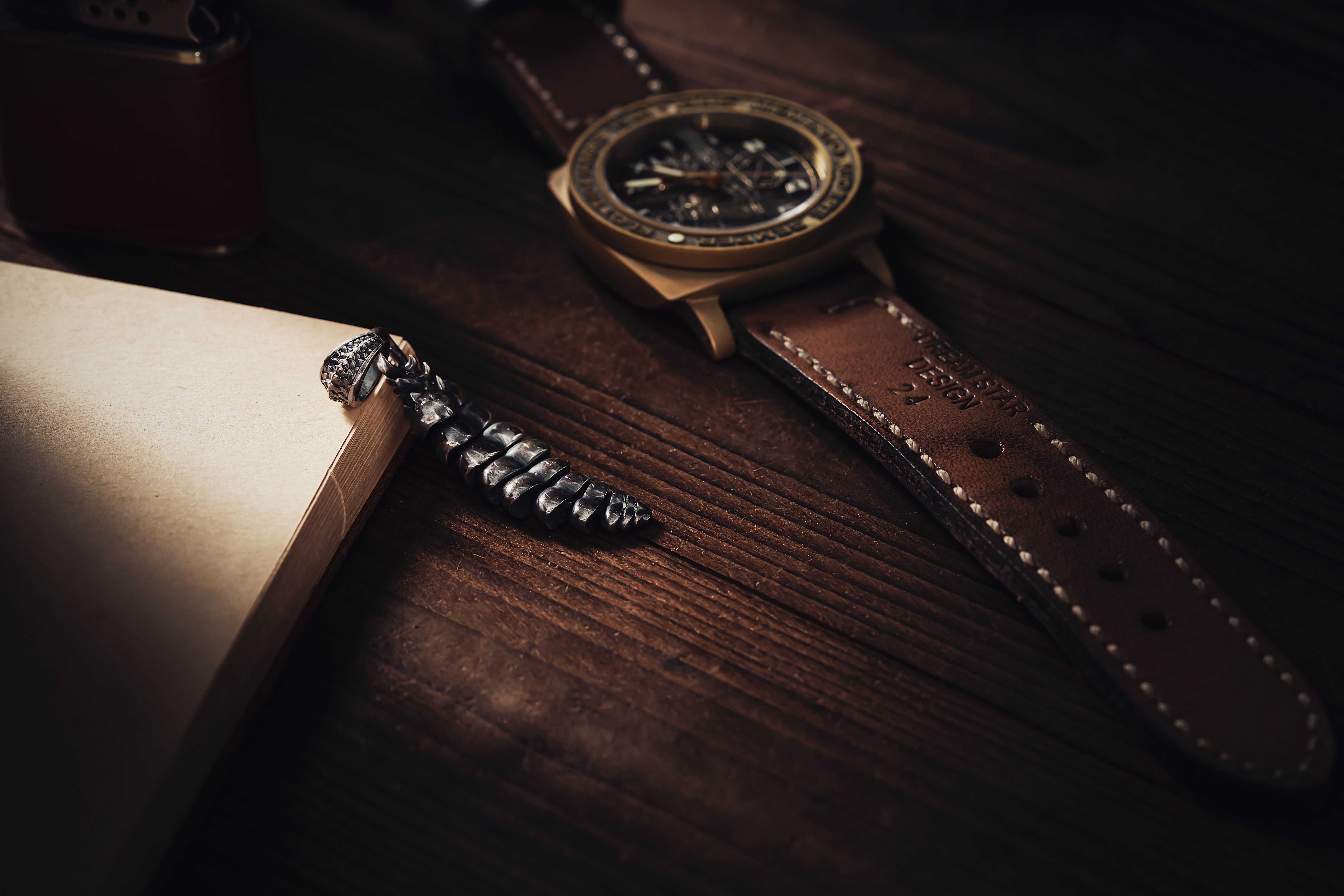Detail of a vintage watch and leather gloves on a wooden shelf