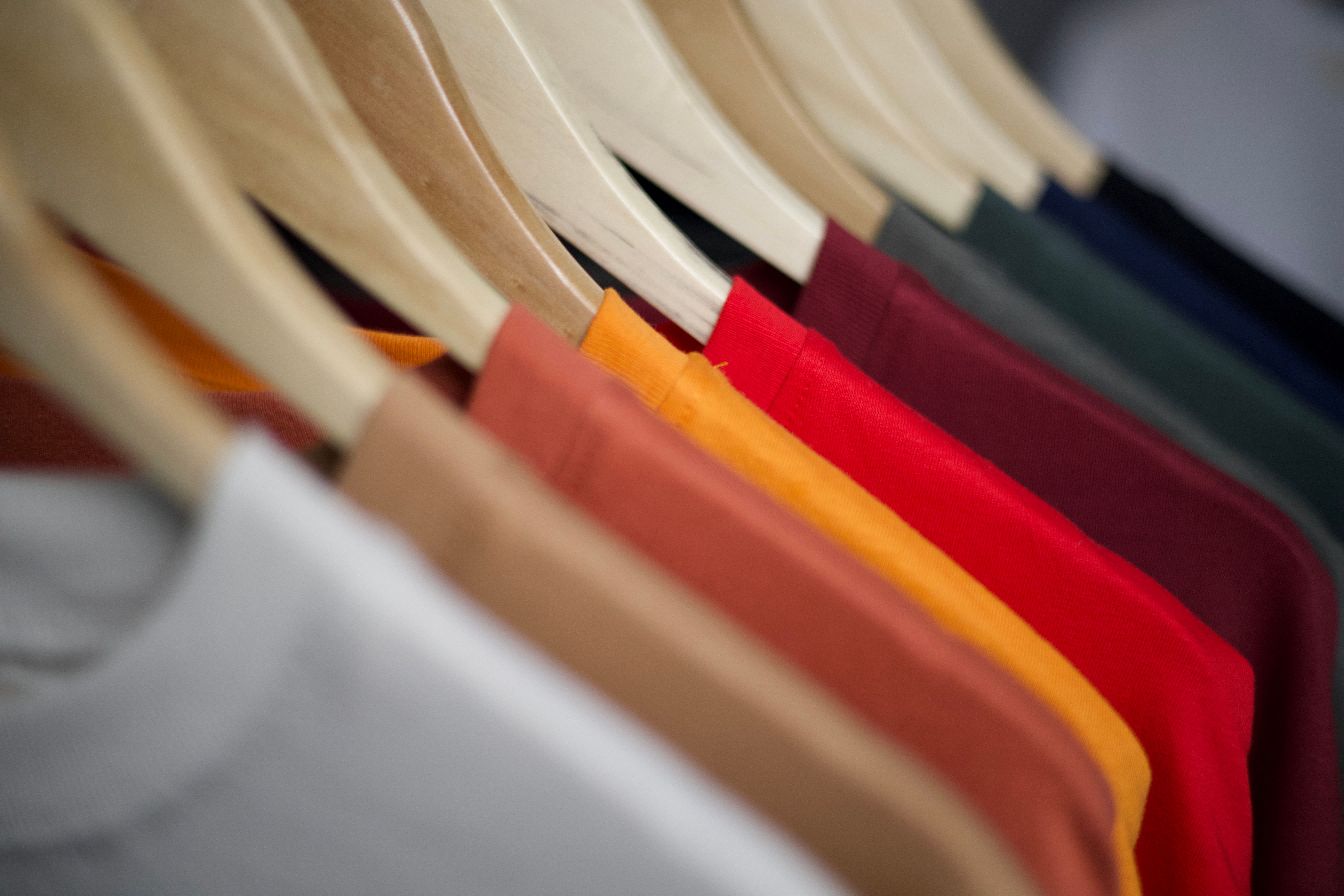 Row of colorful vintage shirts hanging on a rack